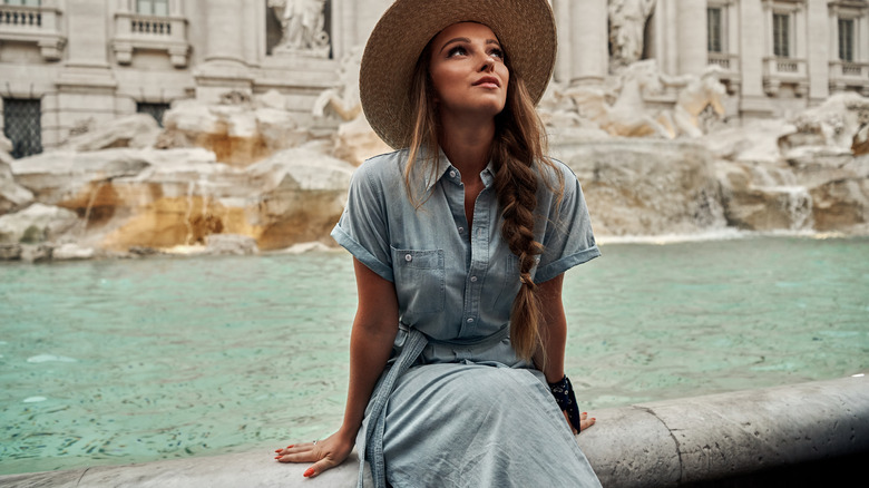 Traveler sitting near fountain