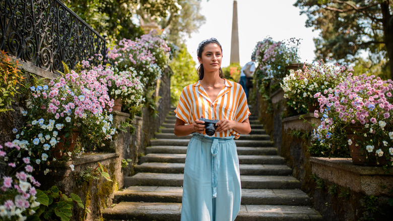 Traveler walking down steps holding camera